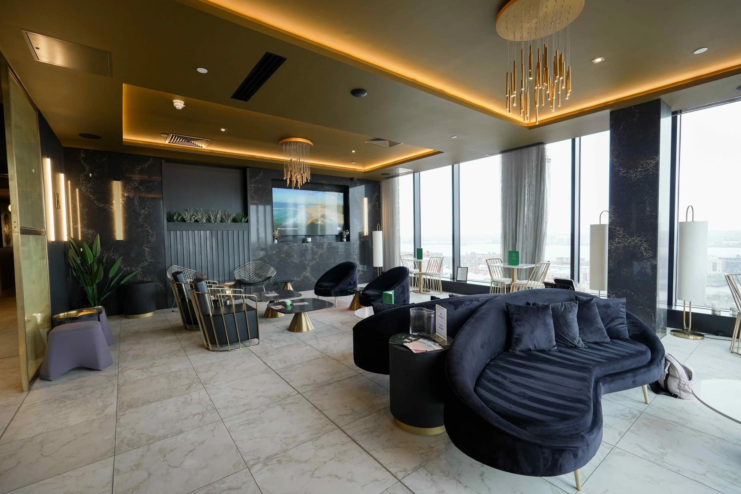 The lounge at Jayde Spa Liverpool — navy sofas and city views.
