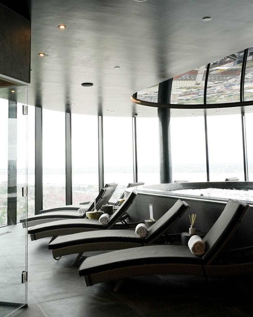 The lounger row along the curved glass at Jayde Spa Liverpool.